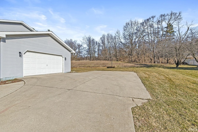 view of side of home with a lawn and driveway