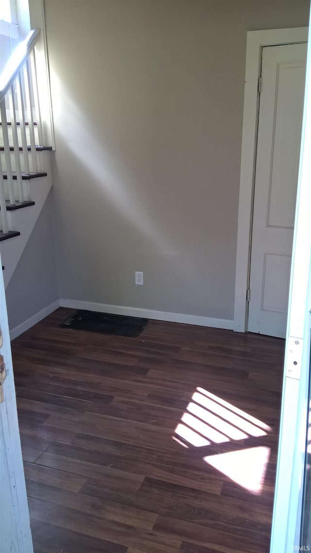 unfurnished room with wood finished floors and baseboards