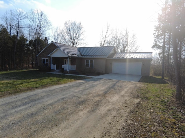 ranch-style house with a front lawn, a standing seam roof, dirt driveway, an attached garage, and metal roof