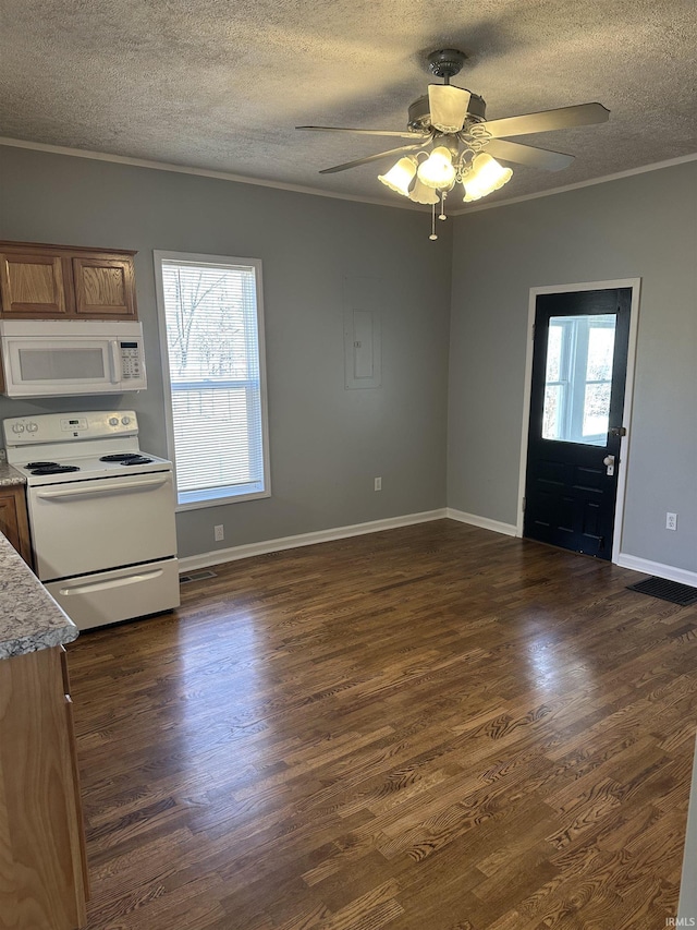 kitchen featuring white appliances, plenty of natural light, dark wood finished floors, and crown molding