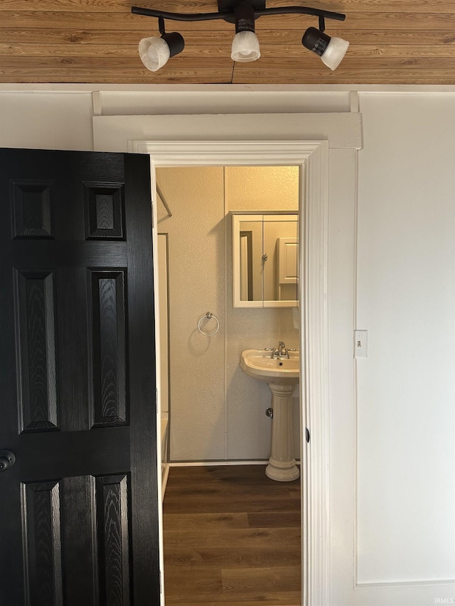 bathroom with wood ceiling and wood finished floors