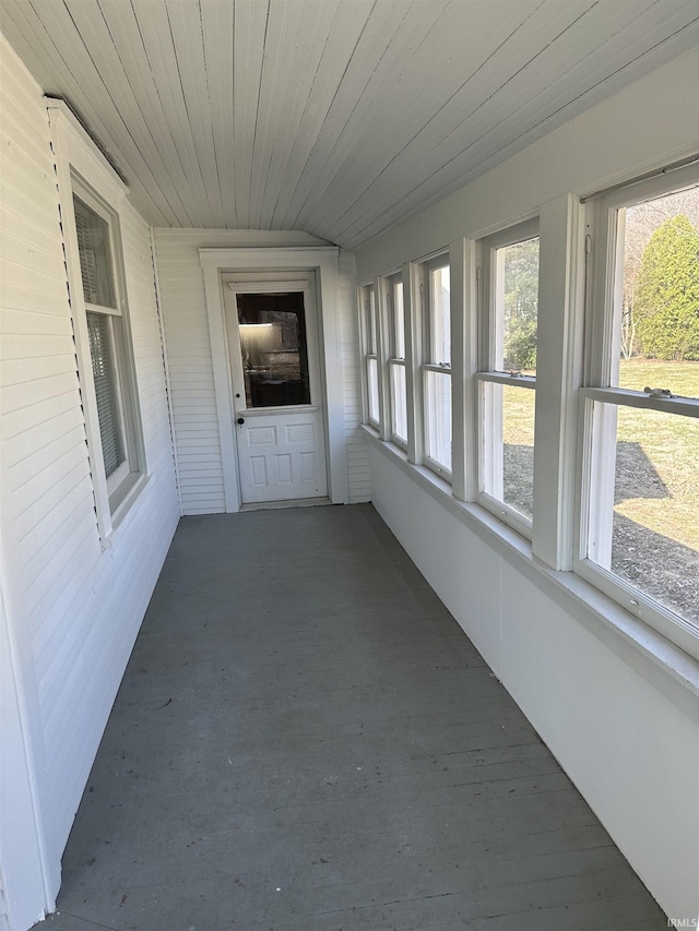 unfurnished sunroom with wooden ceiling