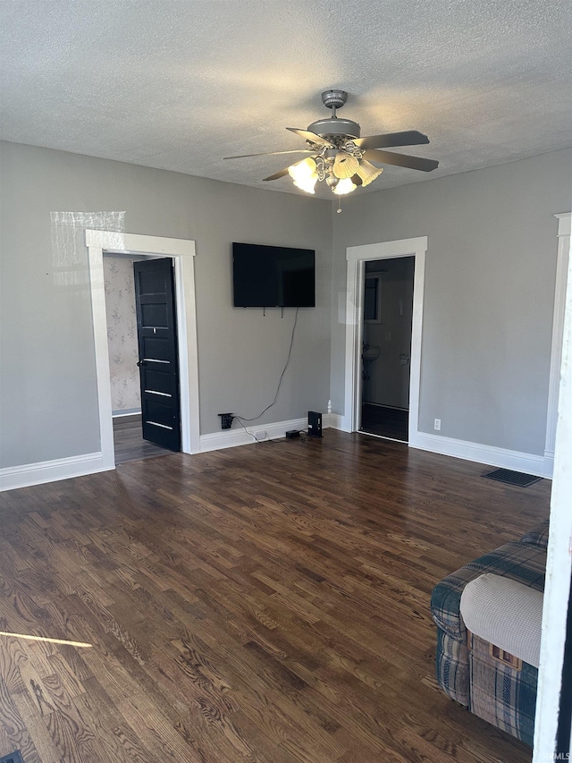 unfurnished living room with baseboards, a textured ceiling, wood finished floors, and a ceiling fan