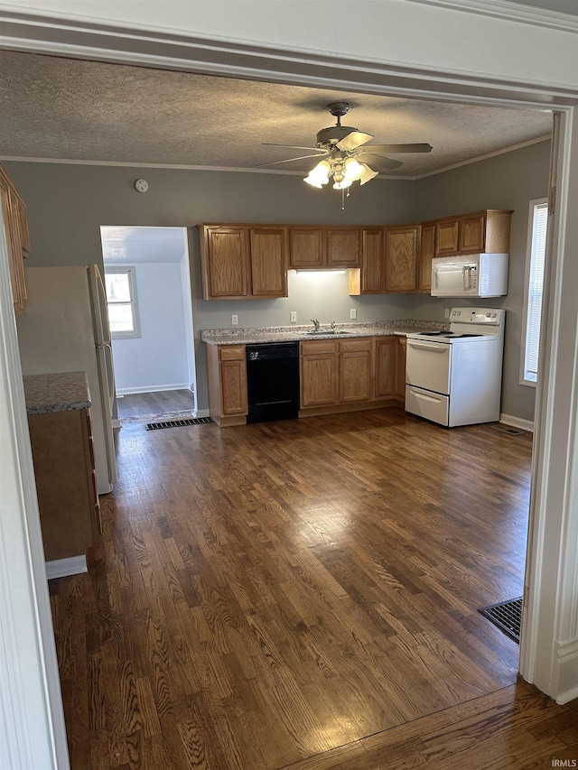 kitchen with white appliances, dark wood-style flooring, ceiling fan, ornamental molding, and a textured ceiling