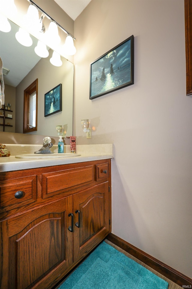 bathroom with vanity and baseboards