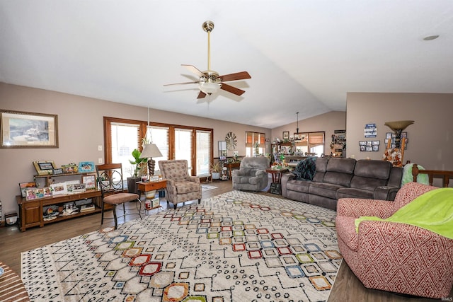 living area featuring lofted ceiling, a ceiling fan, and wood finished floors