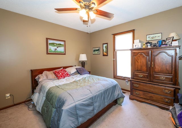 bedroom featuring baseboards, light carpet, and ceiling fan