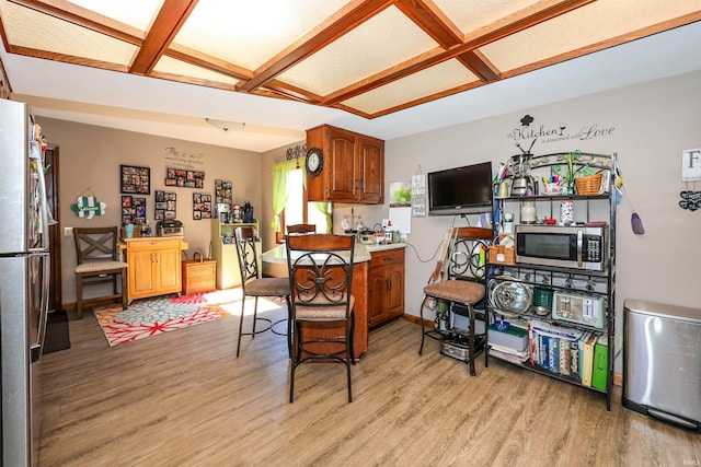 dining room featuring light wood-style flooring and baseboards