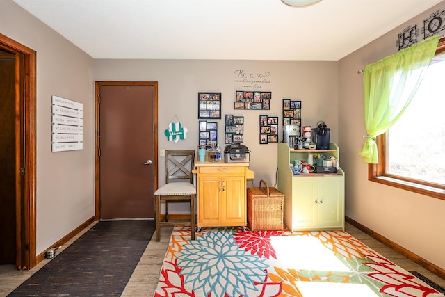 living area with visible vents, baseboards, and wood finished floors