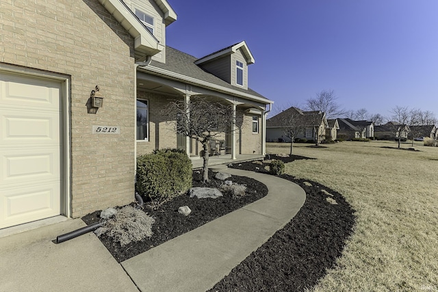 view of exterior entry featuring brick siding