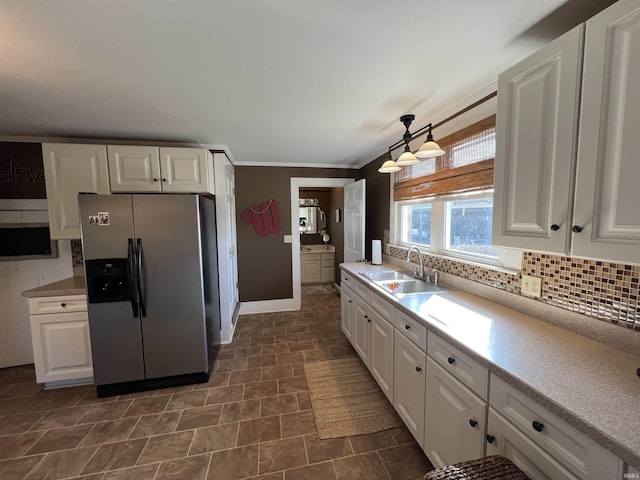 kitchen with white cabinets, stainless steel fridge with ice dispenser, and a sink