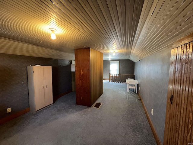 bonus room with visible vents, carpet, and vaulted ceiling