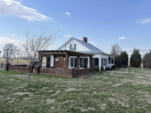 exterior space with brick siding, a lawn, a chimney, a pergola, and a patio