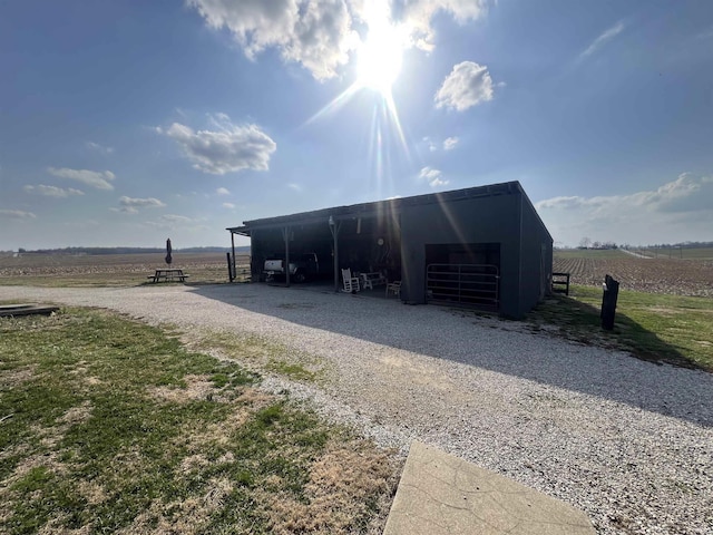 view of pole building featuring a rural view and driveway