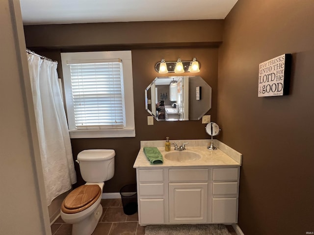 bathroom featuring tile patterned floors, a shower with curtain, toilet, baseboards, and vanity