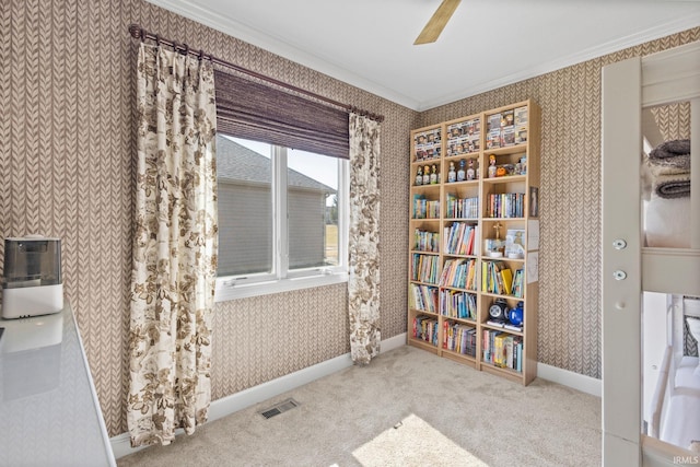 interior space with baseboards, visible vents, wallpapered walls, crown molding, and carpet flooring