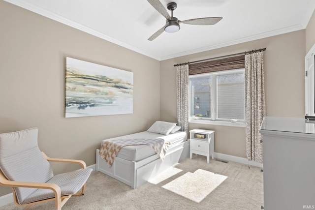 bedroom featuring baseboards, light colored carpet, ceiling fan, and crown molding