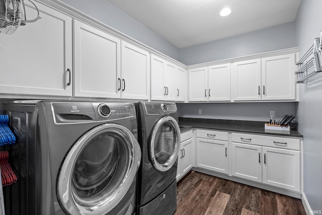 laundry room with cabinet space, separate washer and dryer, dark wood-style flooring, and a textured ceiling