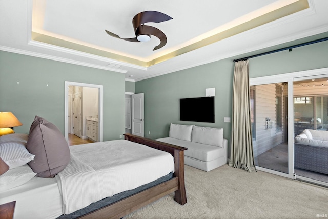 bedroom featuring a tray ceiling, light carpet, a ceiling fan, and crown molding