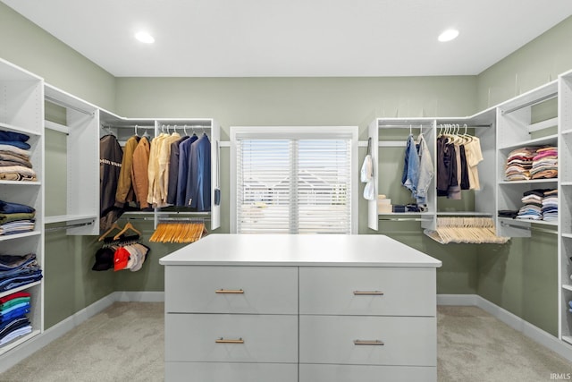 walk in closet with light colored carpet