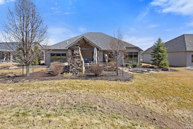 back of property with a garage and a lawn