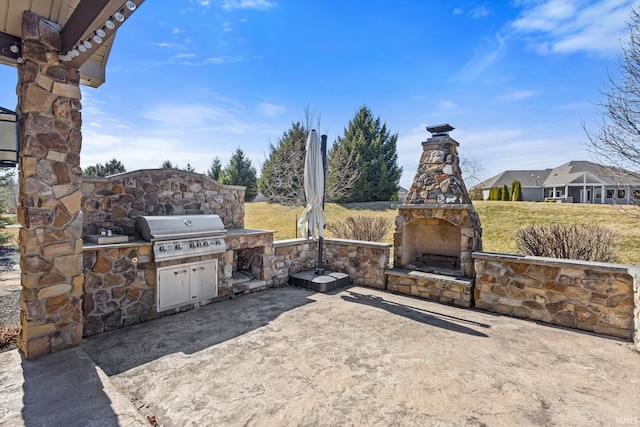 view of patio featuring area for grilling, an outdoor kitchen, and an outdoor stone fireplace