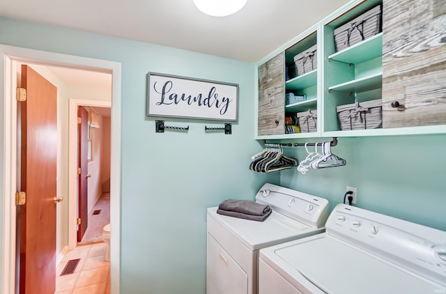 laundry room with washer and dryer, laundry area, light tile patterned flooring, and visible vents