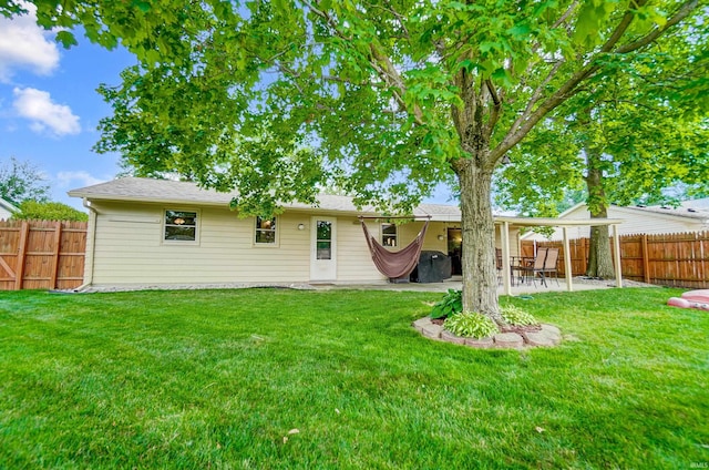 rear view of property featuring a patio, a fenced backyard, and a lawn