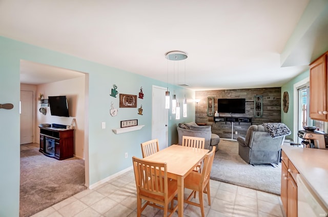 dining room with light carpet, baseboards, and a wealth of natural light