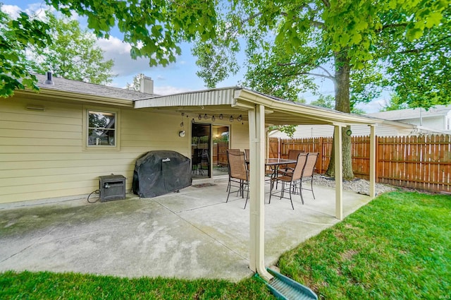 view of patio with grilling area, outdoor dining space, and fence