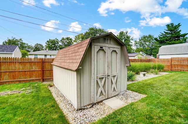 view of shed with a fenced backyard