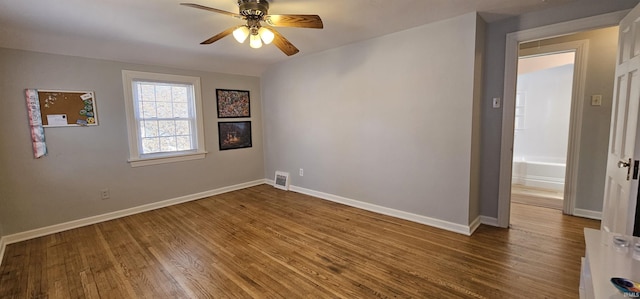 unfurnished room featuring visible vents, baseboards, wood finished floors, and a ceiling fan