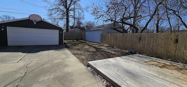 detached garage featuring fence