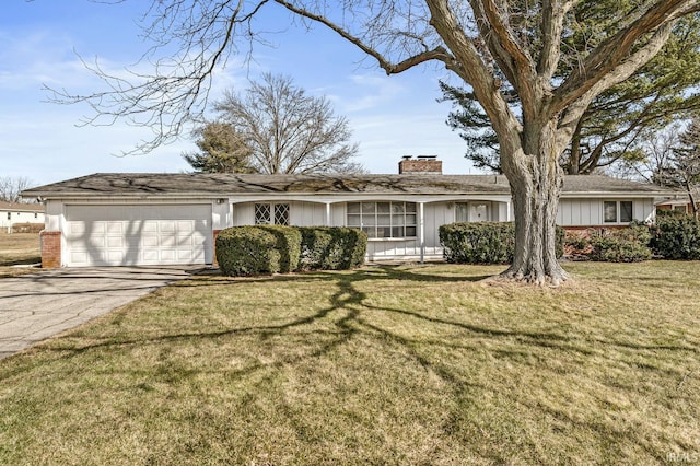 ranch-style home with board and batten siding, a front lawn, aphalt driveway, a chimney, and an attached garage