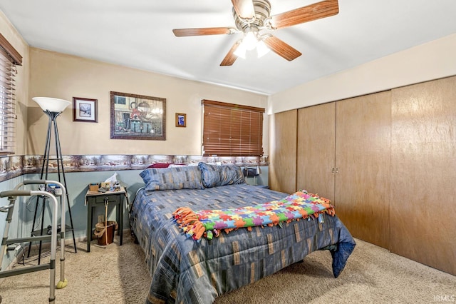 bedroom with a closet, a ceiling fan, and carpet flooring