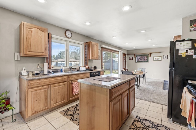 kitchen with black appliances, a sink, a center island, recessed lighting, and light tile patterned flooring