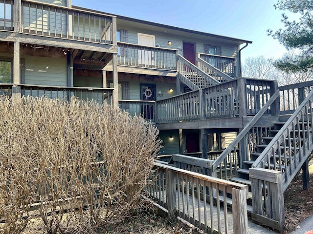 rear view of property featuring stairs