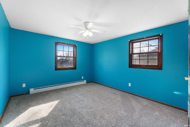 carpeted empty room featuring a baseboard heating unit, a healthy amount of sunlight, baseboards, and ceiling fan