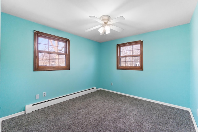 carpeted spare room with a baseboard heating unit, baseboards, and ceiling fan