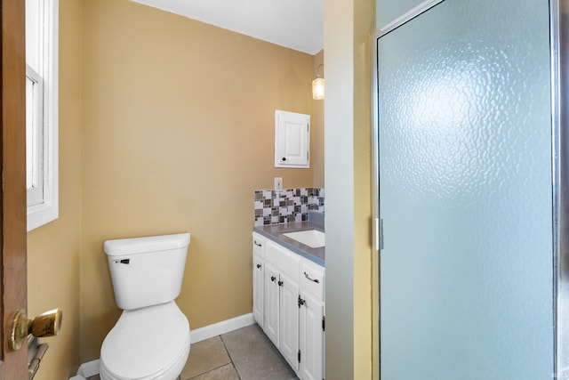 bathroom with vanity, decorative backsplash, a shower stall, tile patterned flooring, and toilet