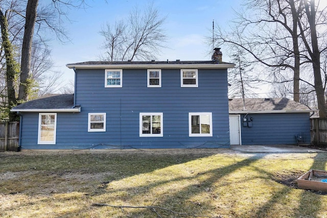 back of property with a patio, a yard, fence, and a chimney