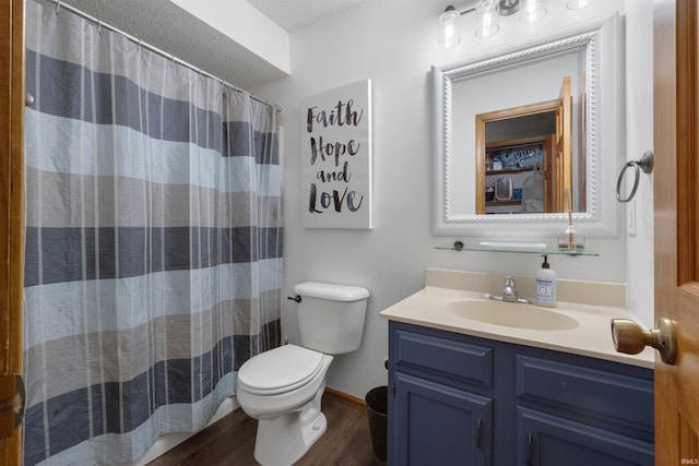 full bathroom with vanity, a shower with shower curtain, wood finished floors, baseboards, and toilet