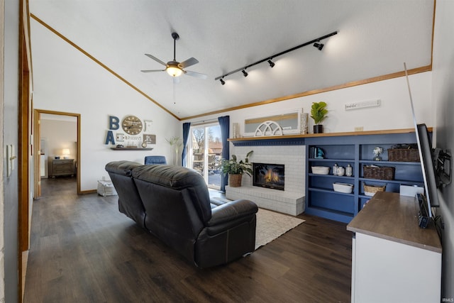 living area with a brick fireplace, high vaulted ceiling, dark wood-type flooring, and ceiling fan