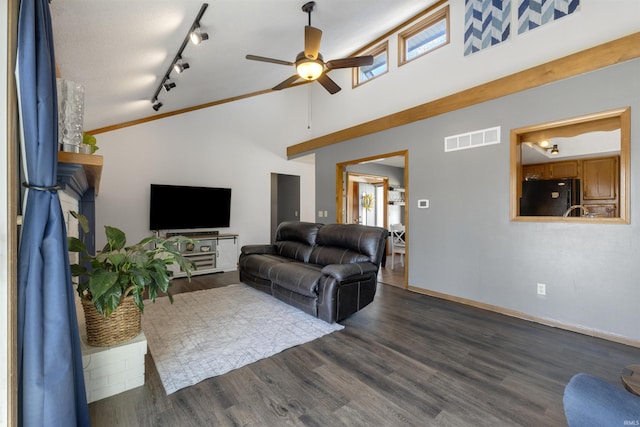 living area featuring visible vents, high vaulted ceiling, dark wood-style flooring, ceiling fan, and track lighting