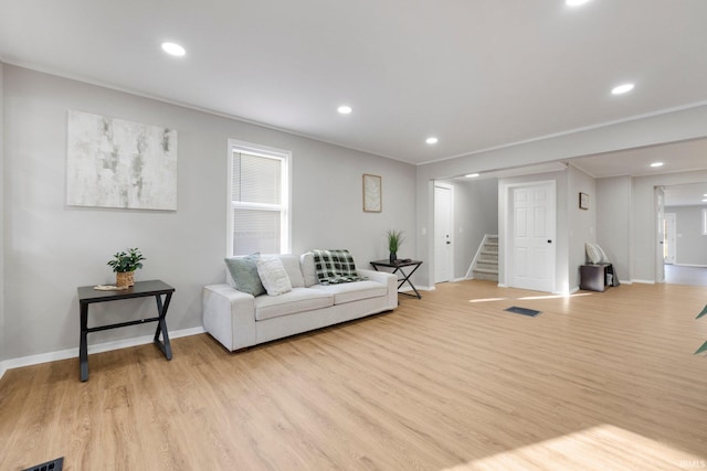 living area featuring stairway, visible vents, baseboards, recessed lighting, and light wood-style floors