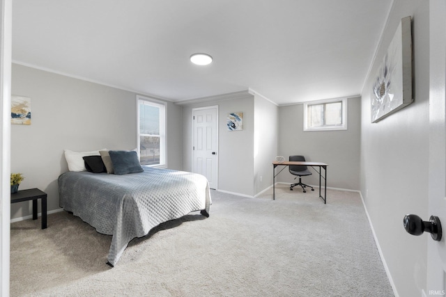 carpeted bedroom with crown molding and baseboards