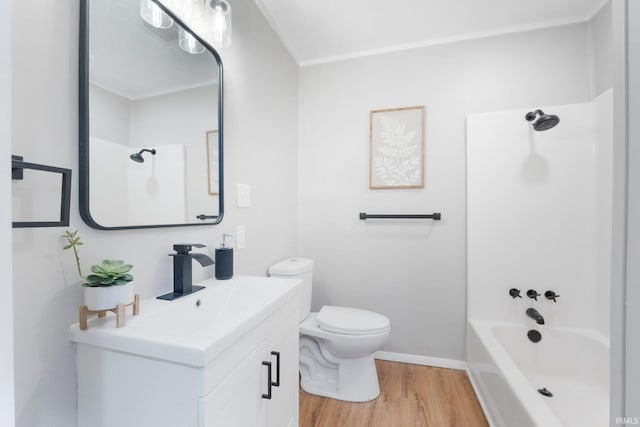 bathroom with vanity, toilet, wood finished floors, and bathtub / shower combination