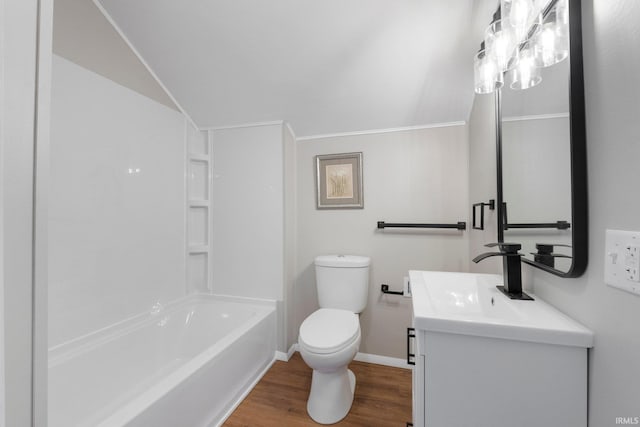 full bathroom featuring vanity, washtub / shower combination, wood finished floors, baseboards, and toilet