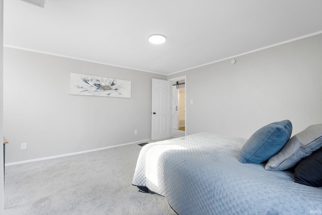 carpeted bedroom with crown molding and baseboards