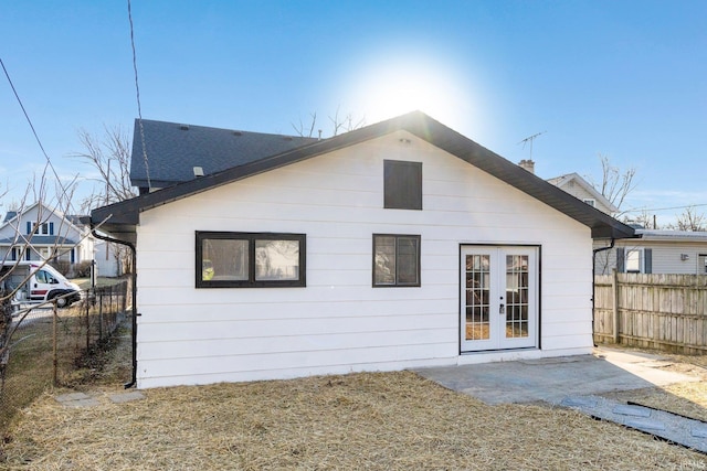 back of property with a patio, fence, and french doors